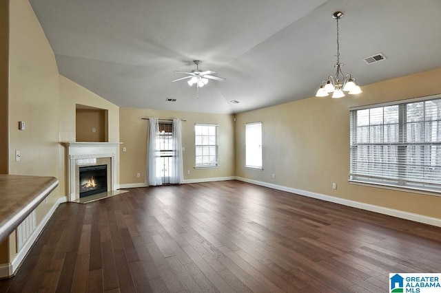 unfurnished living room featuring ceiling fan with notable chandelier, dark wood-type flooring, and vaulted ceiling