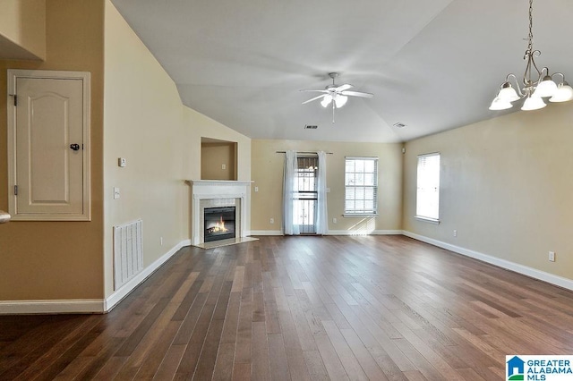 unfurnished living room featuring a high end fireplace, ceiling fan with notable chandelier, dark hardwood / wood-style floors, and lofted ceiling