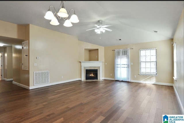 unfurnished living room with vaulted ceiling, dark hardwood / wood-style flooring, and ceiling fan with notable chandelier