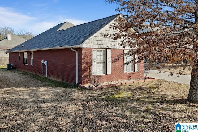 view of side of home featuring central AC unit