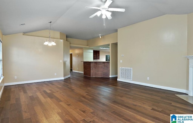 unfurnished living room with ceiling fan with notable chandelier, dark hardwood / wood-style flooring, and lofted ceiling