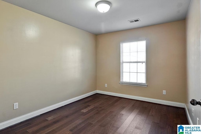 spare room with dark hardwood / wood-style flooring