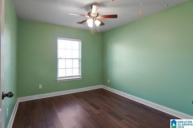 empty room with ceiling fan and dark hardwood / wood-style floors