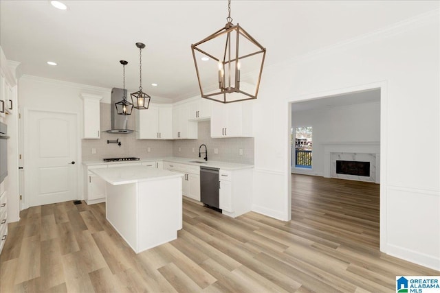 kitchen with white cabinetry, wall chimney range hood, stainless steel appliances, and pendant lighting