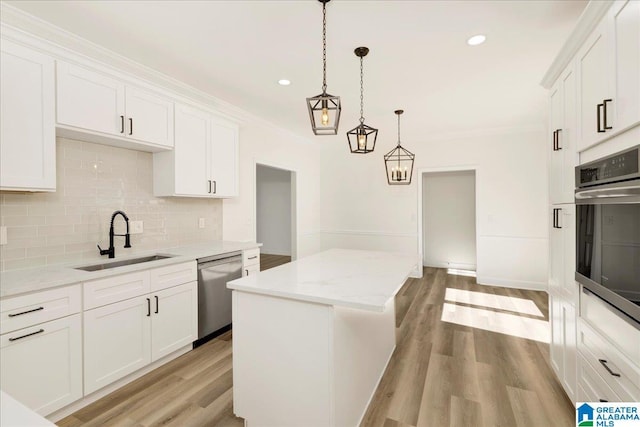 kitchen with white cabinetry, pendant lighting, dishwasher, and sink