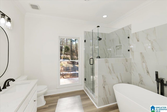 full bathroom featuring separate shower and tub, ornamental molding, wood-type flooring, and vanity