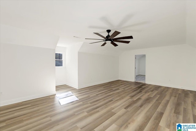 additional living space with vaulted ceiling, ceiling fan, and light hardwood / wood-style flooring