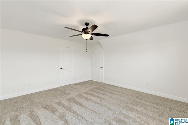 unfurnished room with ceiling fan and light colored carpet