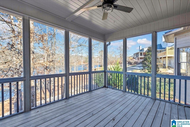 unfurnished sunroom with ceiling fan