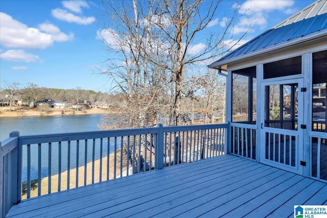 wooden deck featuring a water view and a sunroom