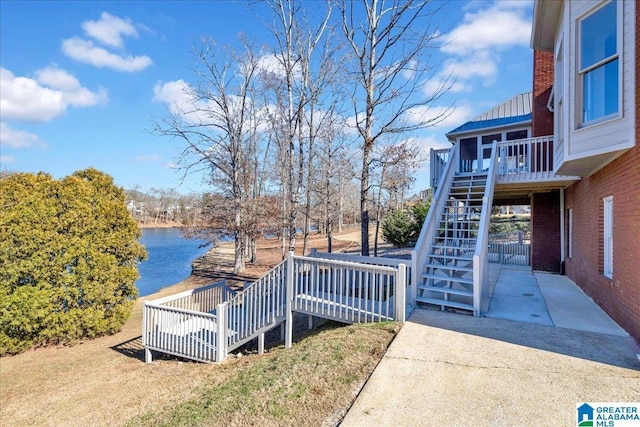 view of yard with a patio area and a deck with water view