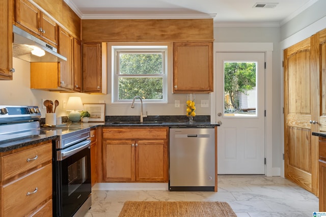 kitchen featuring stainless steel appliances, dark stone countertops, crown molding, and sink