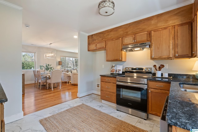 kitchen featuring pendant lighting, a notable chandelier, dark stone countertops, electric range, and ornamental molding