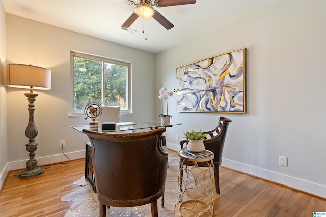 home office with ceiling fan and light wood-type flooring