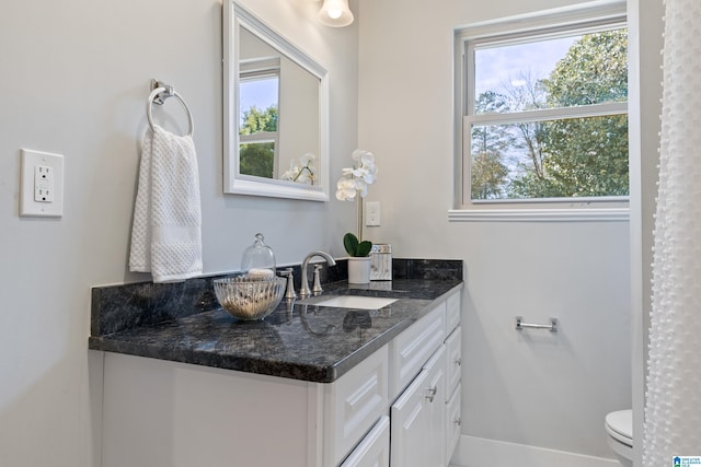 bathroom featuring toilet and vanity