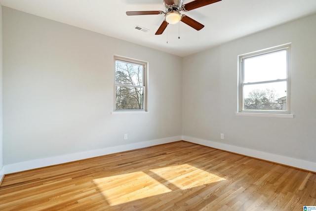 spare room with light wood-type flooring and ceiling fan