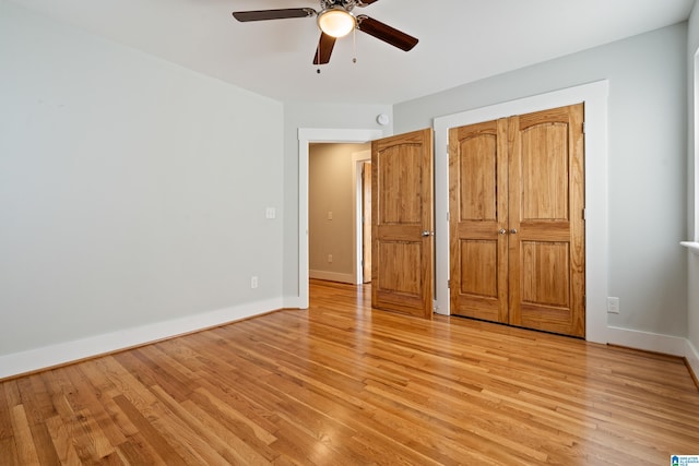 unfurnished bedroom with ceiling fan and light hardwood / wood-style flooring