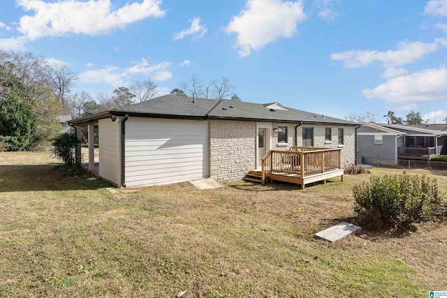 rear view of house featuring a yard and a wooden deck