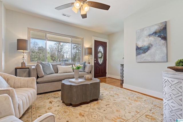 living room featuring ceiling fan and light hardwood / wood-style floors