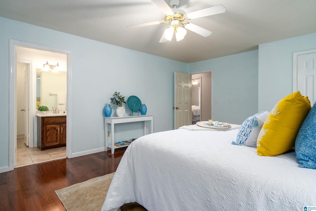 bedroom featuring ensuite bath, ceiling fan, and light hardwood / wood-style floors