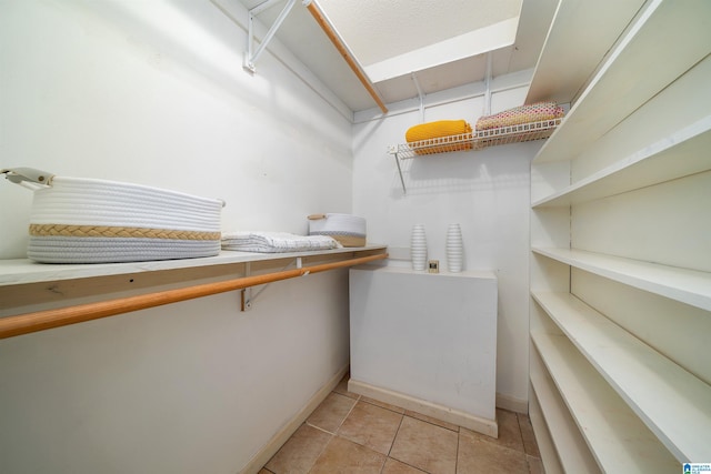 spacious closet featuring light tile patterned floors