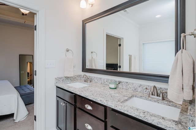 bathroom featuring crown molding and vanity