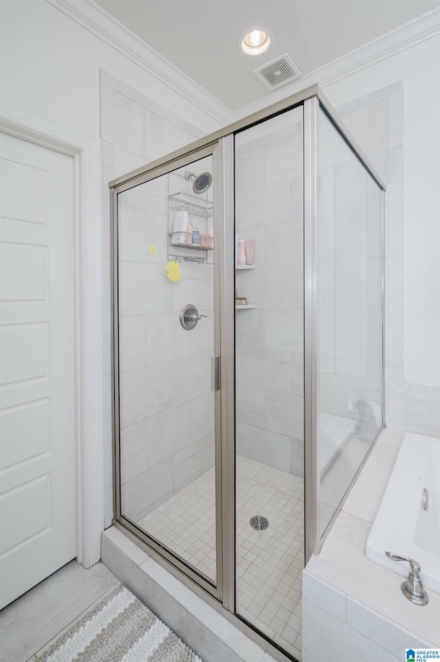 bathroom featuring separate shower and tub and crown molding