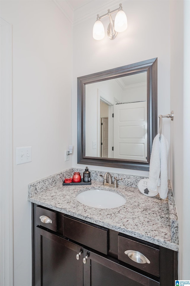 bathroom with crown molding and vanity