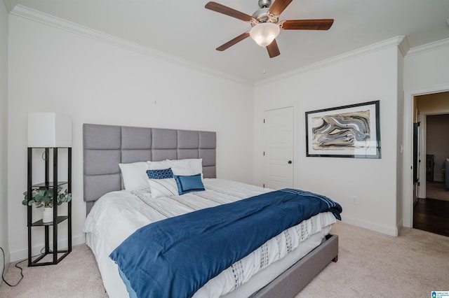 carpeted bedroom featuring ceiling fan and crown molding