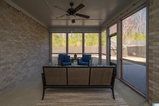 sunroom featuring ceiling fan