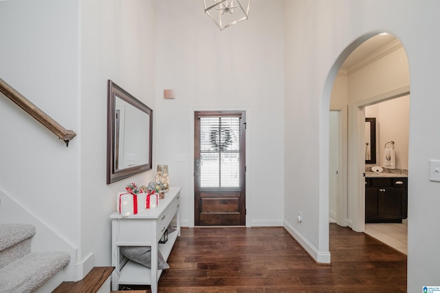 entrance foyer with dark hardwood / wood-style flooring and ornamental molding