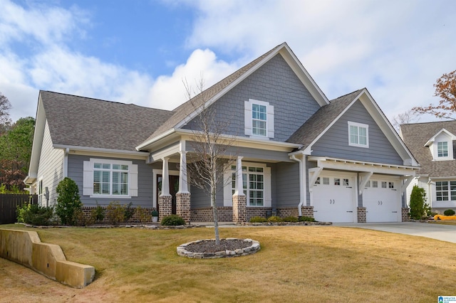 craftsman house featuring a front yard and a garage