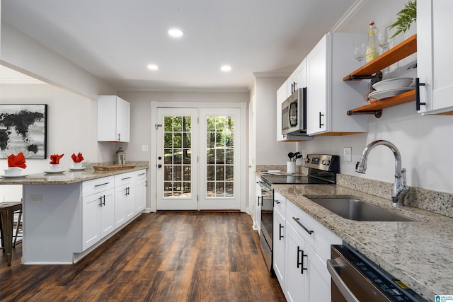 kitchen featuring light stone countertops, white cabinetry, sink, and stainless steel appliances