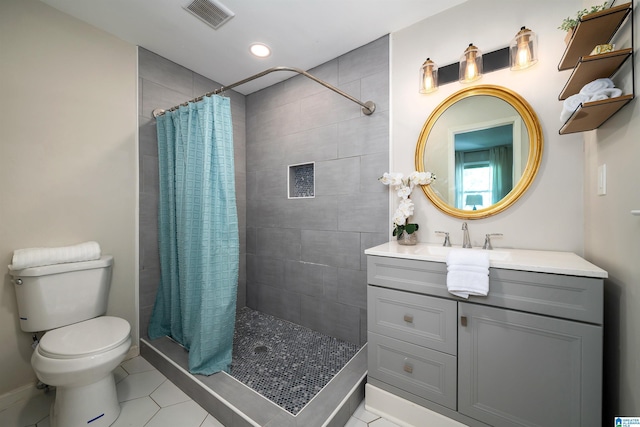 bathroom with tile patterned floors, curtained shower, vanity, and toilet