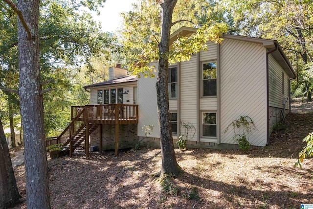 rear view of property with a wooden deck