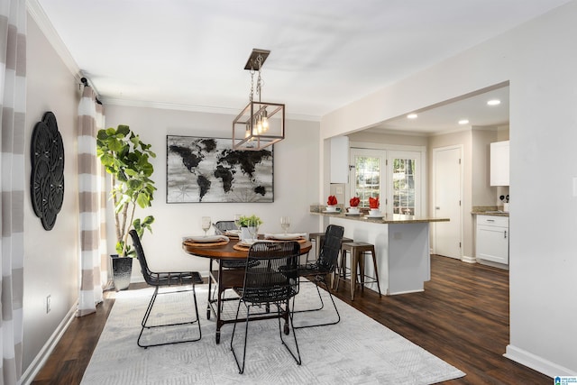 dining space featuring ornamental molding, dark hardwood / wood-style floors, and a notable chandelier