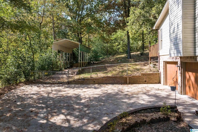 view of yard featuring a carport and a garage