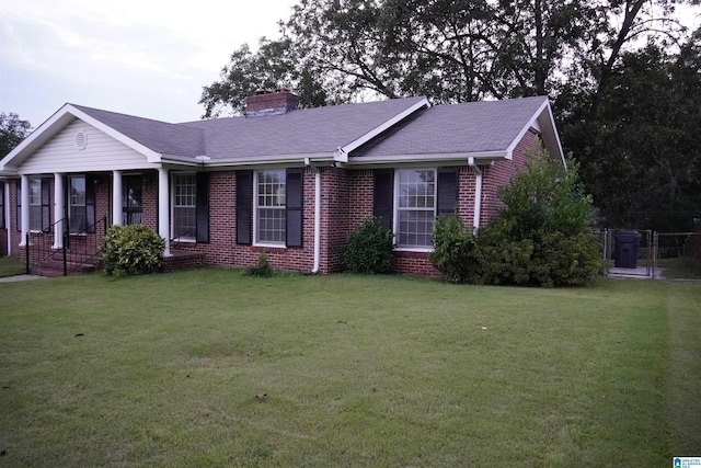 ranch-style house featuring a porch and a front yard