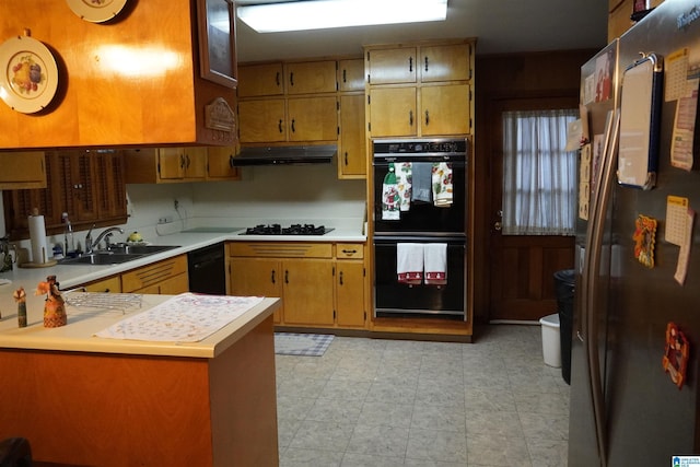 kitchen featuring kitchen peninsula, sink, and black appliances