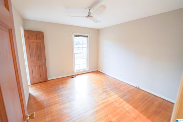 empty room with ceiling fan and light wood-type flooring