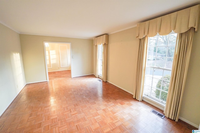 unfurnished room featuring light parquet flooring and ornamental molding