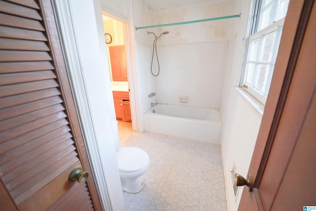 full bathroom featuring tiled shower / bath combo, vanity, and toilet