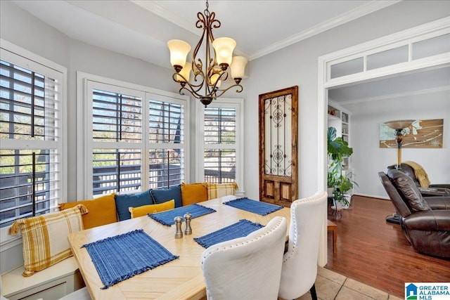 tiled dining space featuring crown molding, an inviting chandelier, and a healthy amount of sunlight