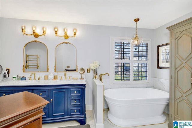 bathroom featuring vanity, a bathtub, a notable chandelier, and tile patterned floors