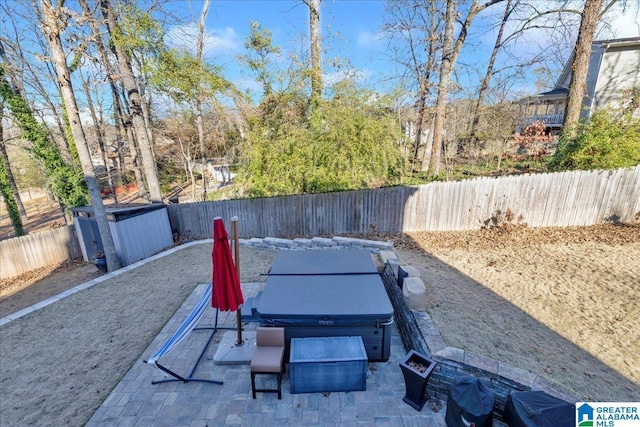 entry to storm shelter with a jacuzzi and a patio