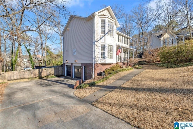 view of home's exterior featuring a garage and a lawn