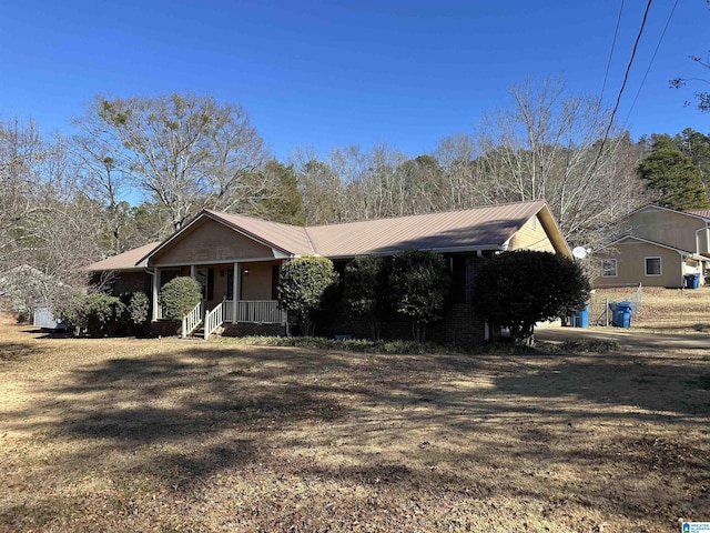 ranch-style house with a front lawn and covered porch