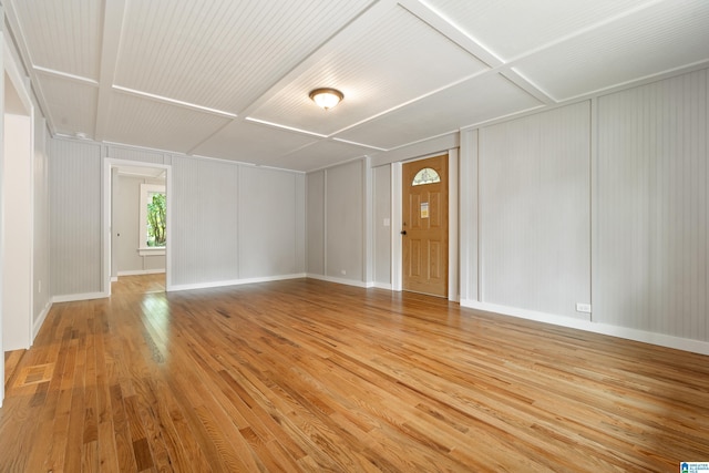 spare room featuring wood-type flooring and coffered ceiling