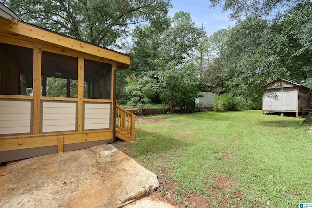 view of yard featuring a storage shed and a sunroom