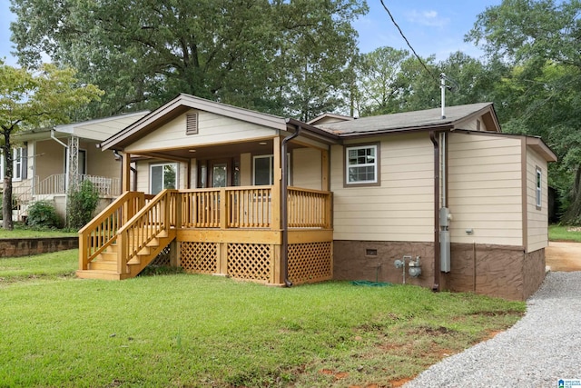 rear view of property featuring a yard and a porch